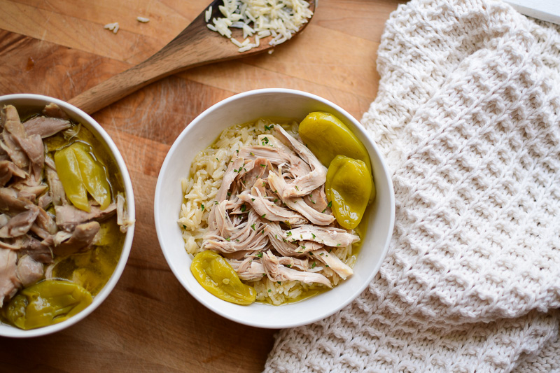 A bowl with chicken, pepperoncini and rice