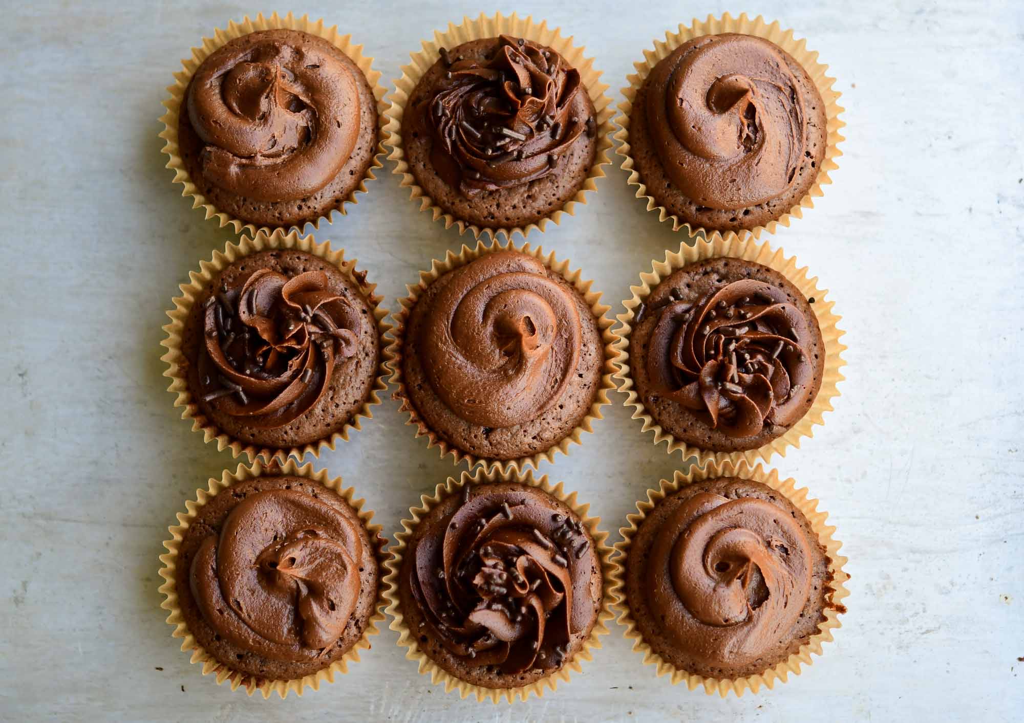 Brownie cupcakes with chocolate icing and chocolate sprinkles