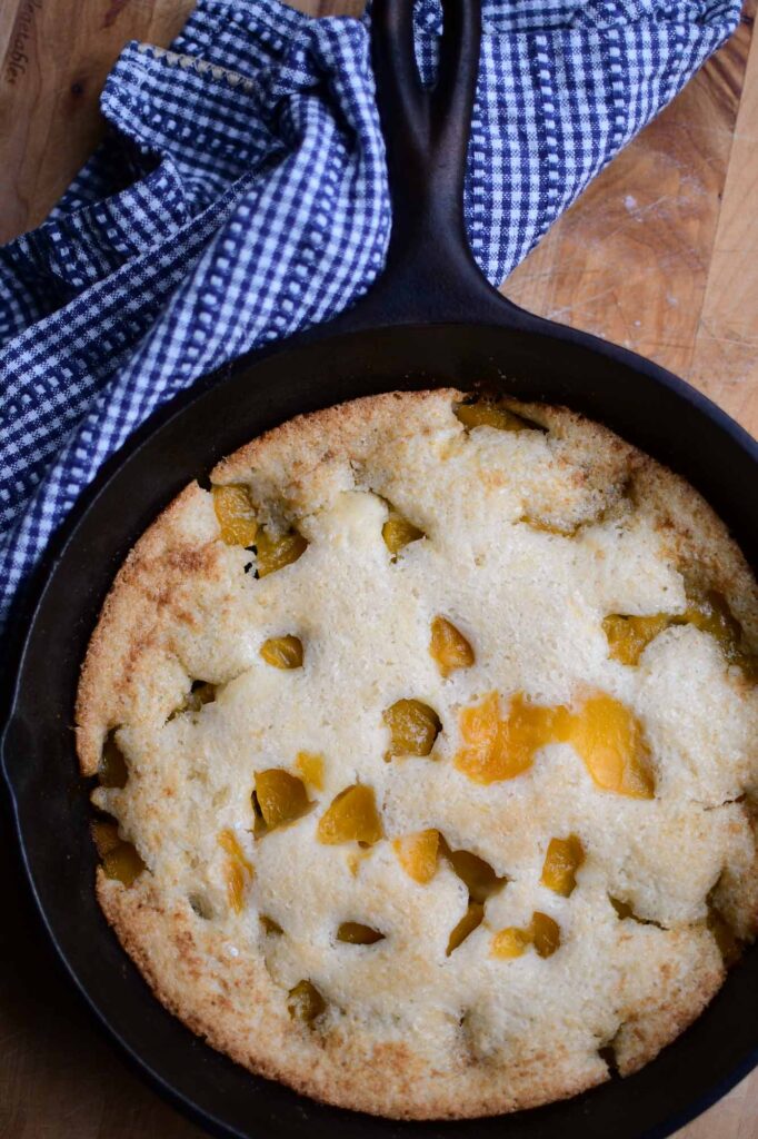 Cast iron skillet peach cobbler. In 12 inch cast iron skillet melt 1 stick  butter, add 4 - 15 oz cans peaches with s…