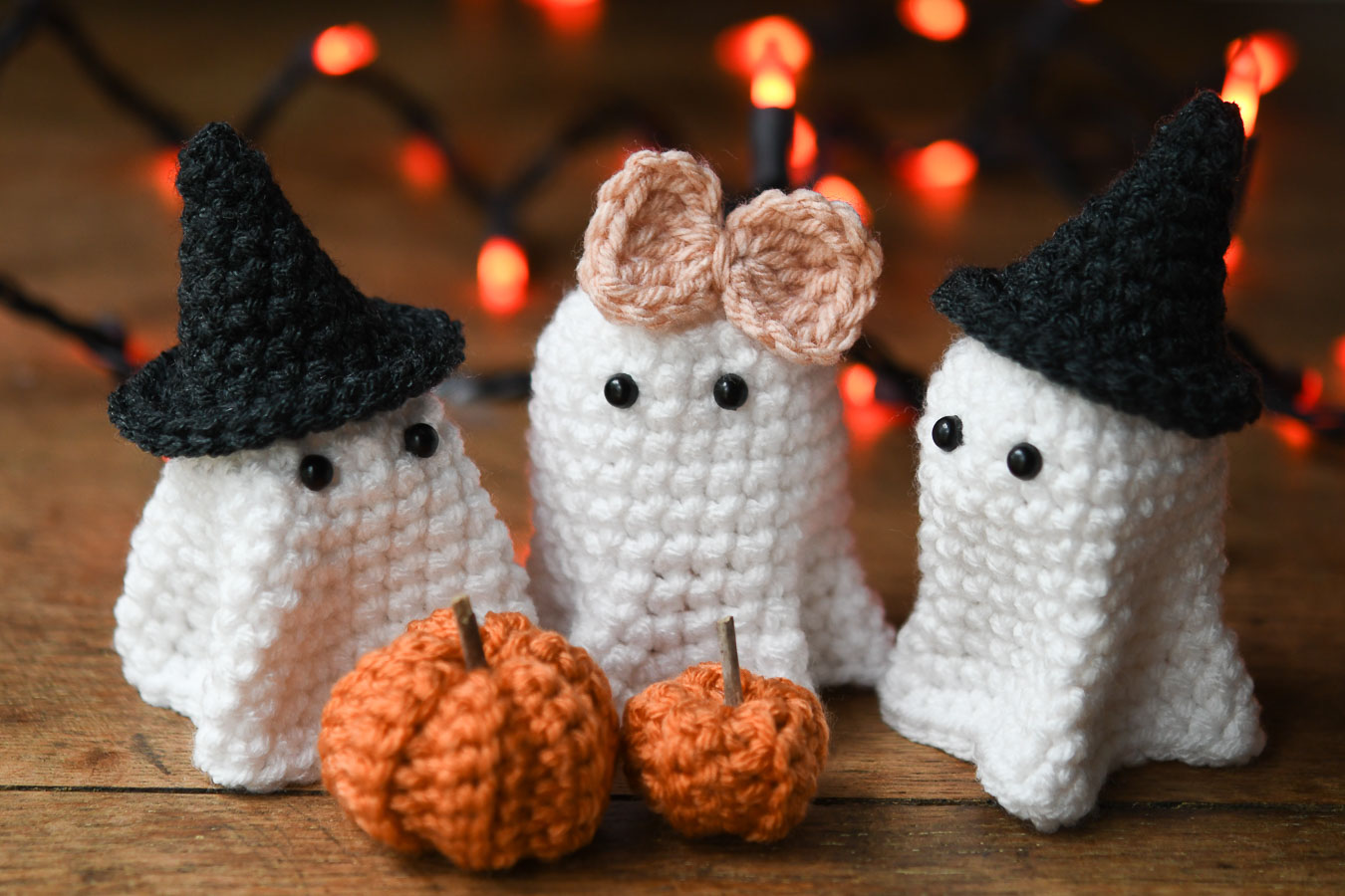 Three tiny ghosts and little pumpkins