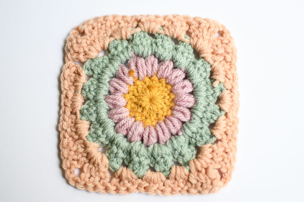 The back of a sunburst granny square with ends woven in and clipped off. 