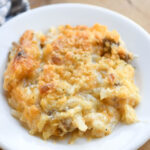 A close up photo of a plate of hashbrown and ground beef casserole showing the texture of the meal