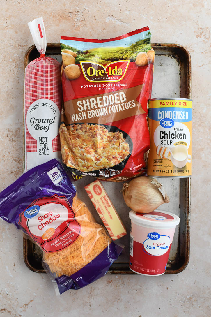 Ingredients for hash brown casserole on a baking tray