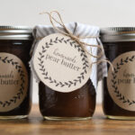 Jars of homemade spiced pear butter with brown craft labels