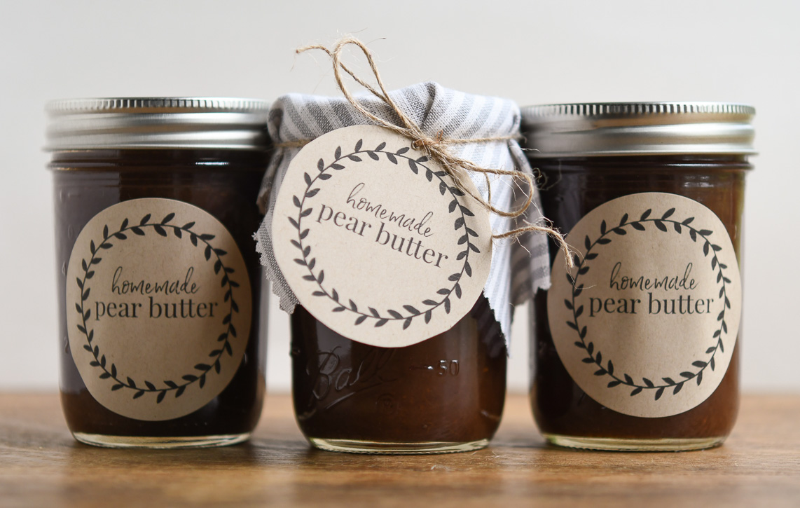 Jars of homemade spiced pear butter with brown craft labels