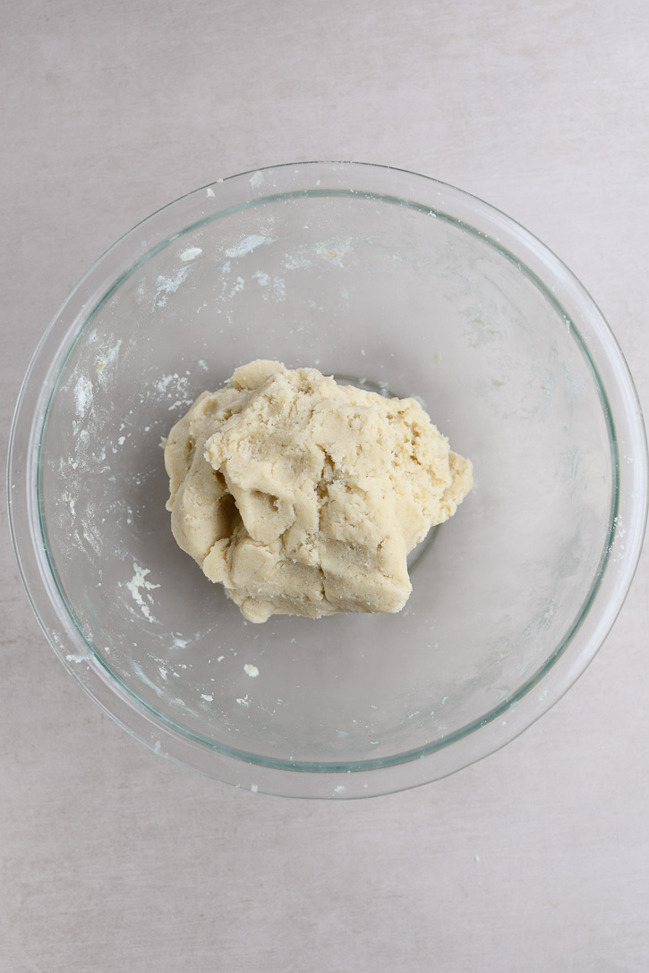 A ball of snowball shortbread cookie dough after completely mixing it together 