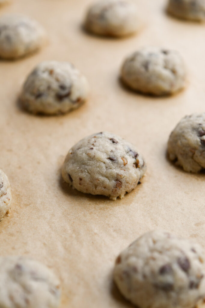 A close up of the height and texture of baked snowball cookies before rolling in powdered sugar 