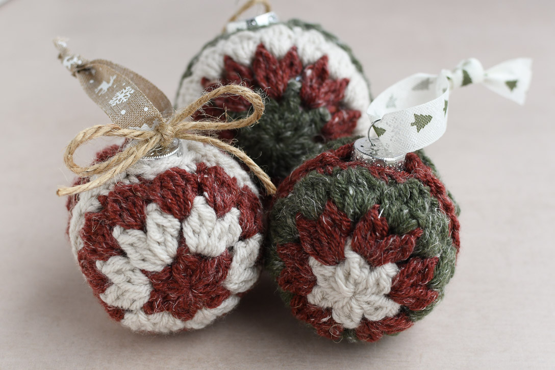 Three ornaments tied with different ribbons