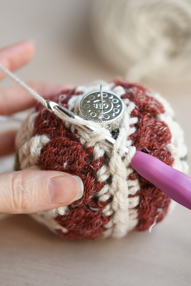 Slip stitching the final stitches at the top of the ornament 