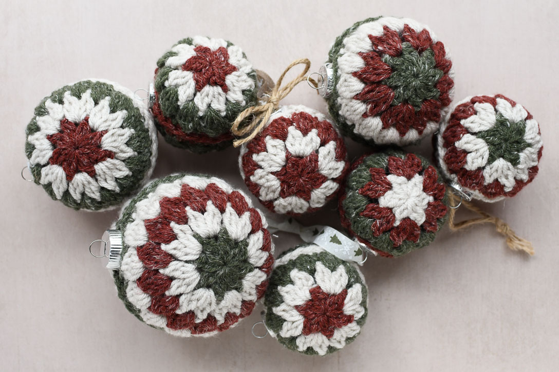 a group of finished crochet christmas ornaments