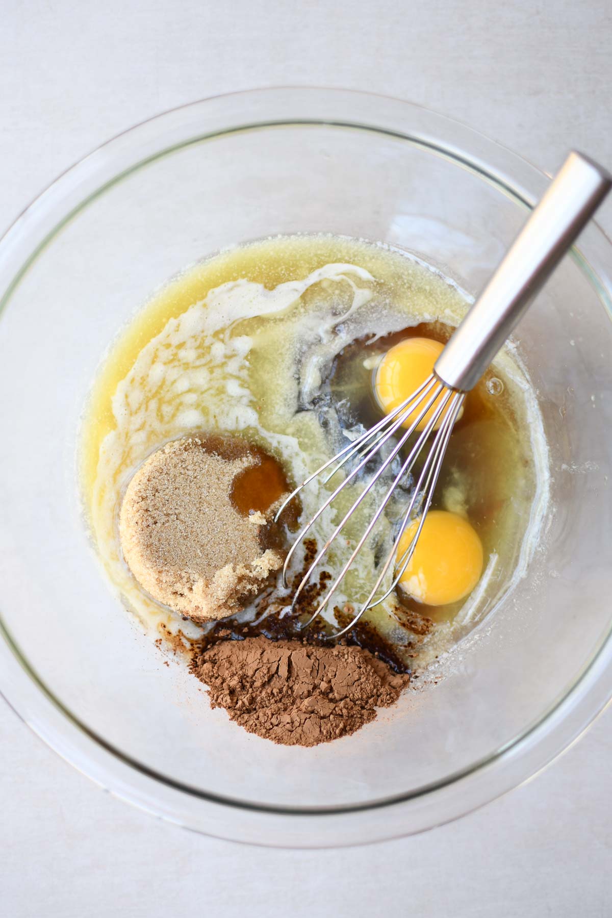 Filling ingredients in a mixing bowl with a wire whisk