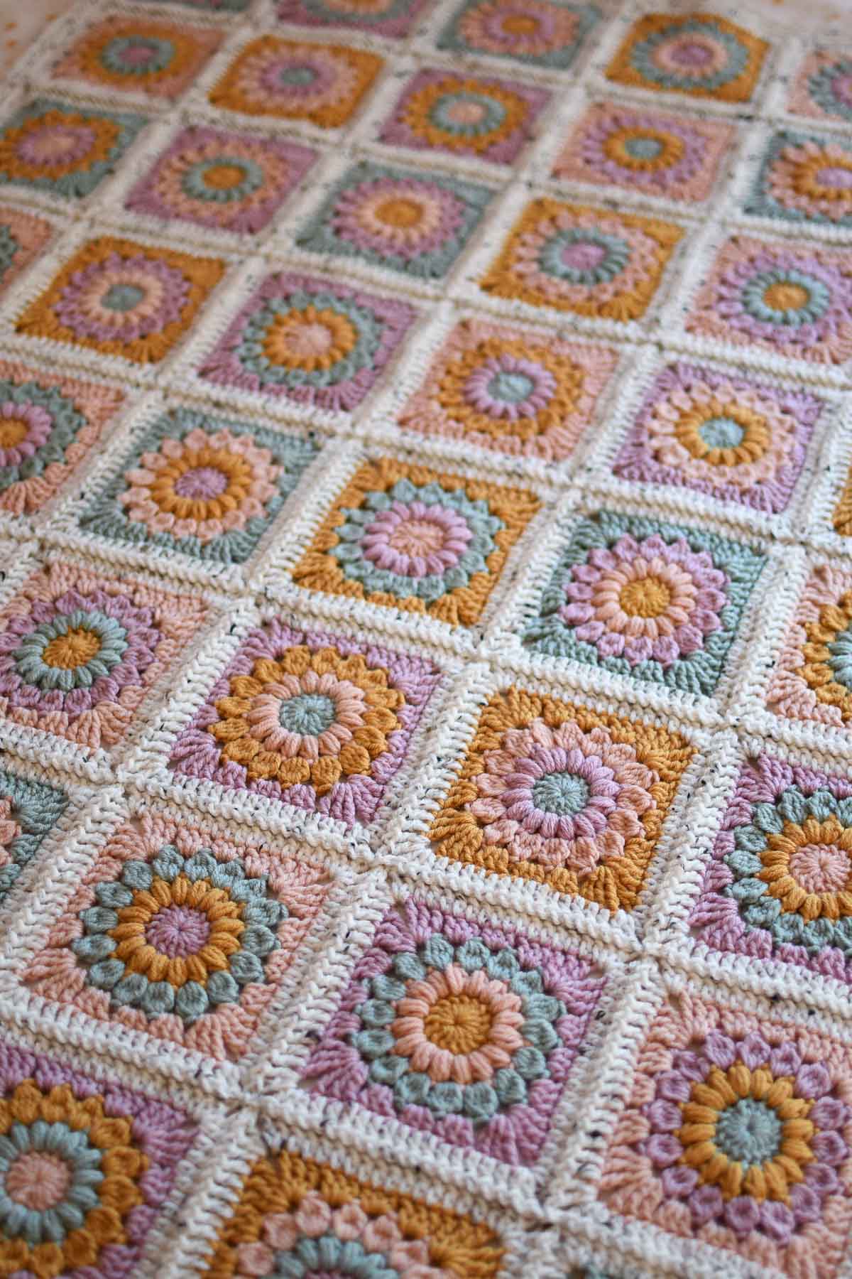 Spring Sunburst Granny Square Blanket laying on a flat surface