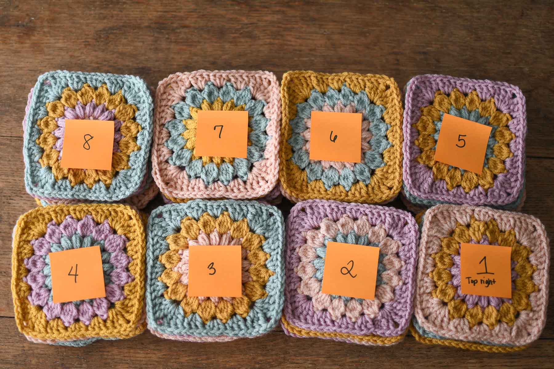 Stacks of granny squares ready to be joined in order